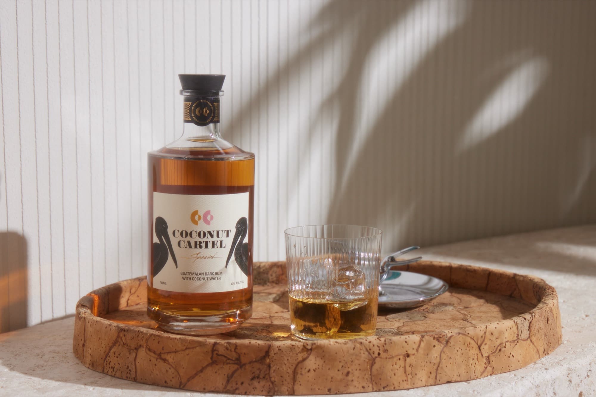 A glass of Coconut Cartel rum on a bar — industry and trade dispatches