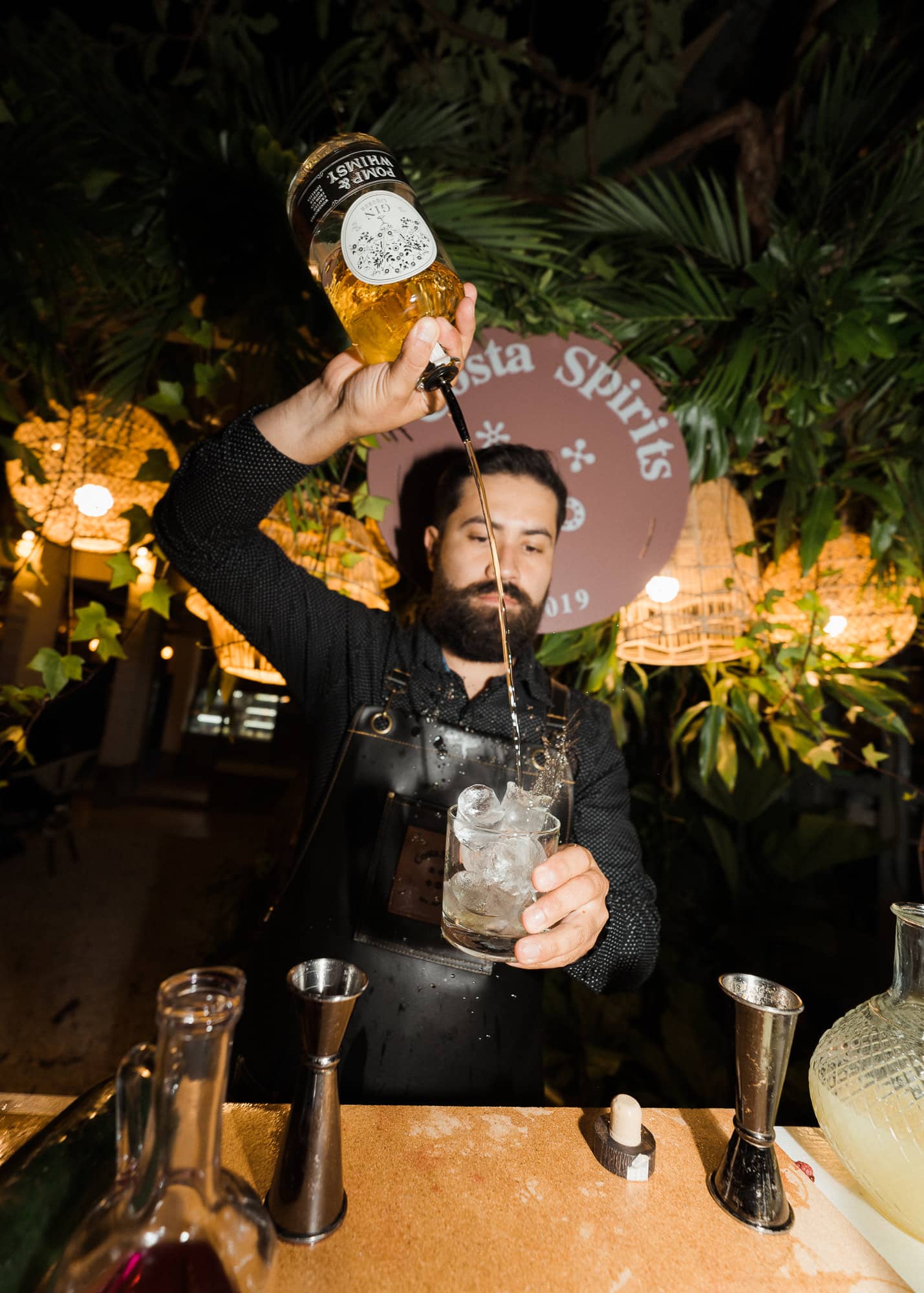 A bartender building a drink at the Costa Spirits bar