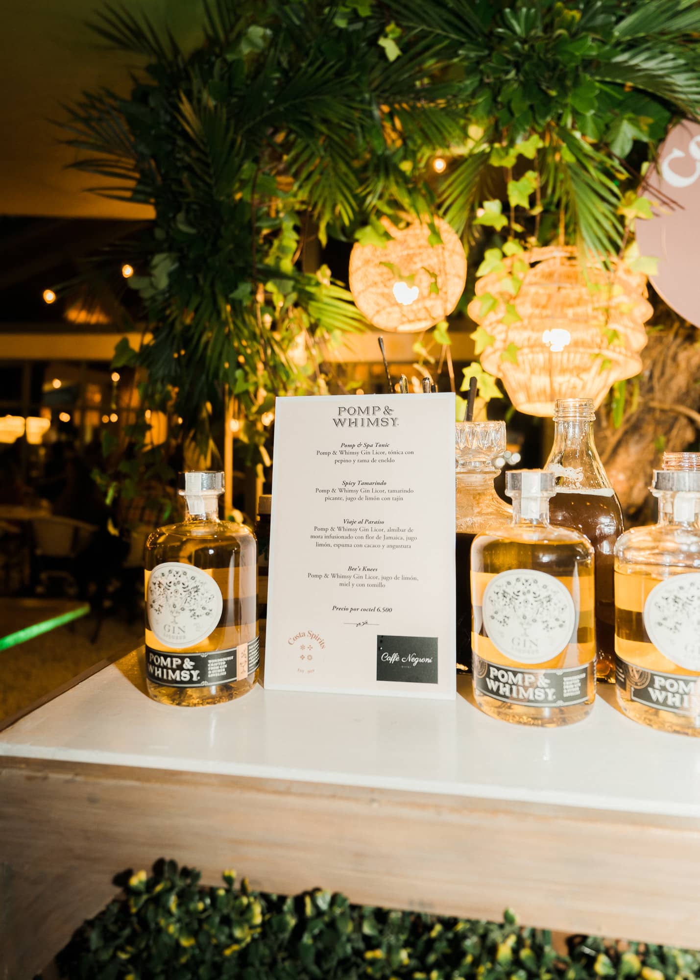 Portfolio bottles and a printed menu at a Costa Spirits event